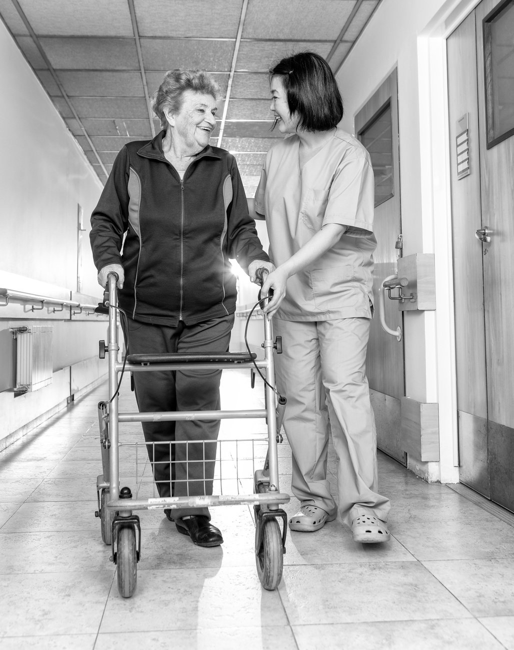 Healthcare professional helping the elderly woman after a stroke in daily physiotherapy exercises